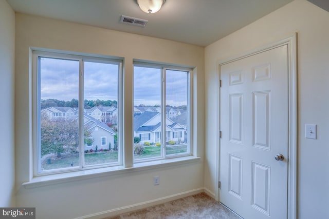 4902 E Pebble Ln Unit E, Milford, DE 19963 - carpeted empty room featuring visible vents, baseboards, and a residential view