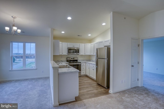 4902 E Pebble Ln Unit E, Milford, DE 19963 - kitchen featuring light colored carpet, appliances with stainless steel finishes, white cabinets, and a sink
