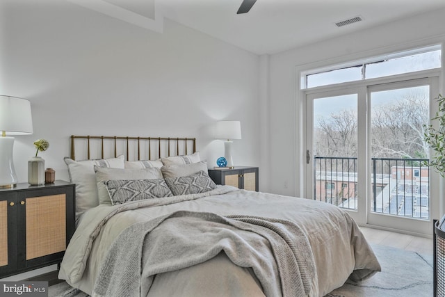 bedroom featuring a ceiling fan, access to outside, and visible vents