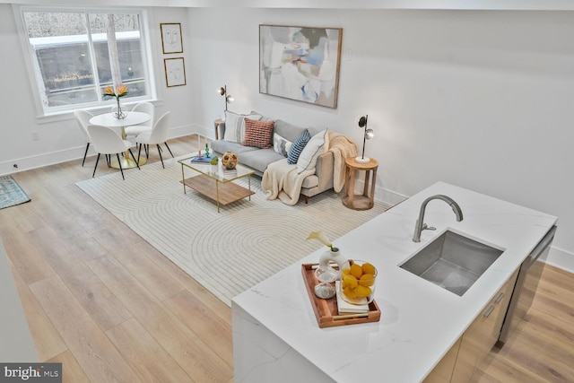 living room featuring light wood-type flooring and baseboards