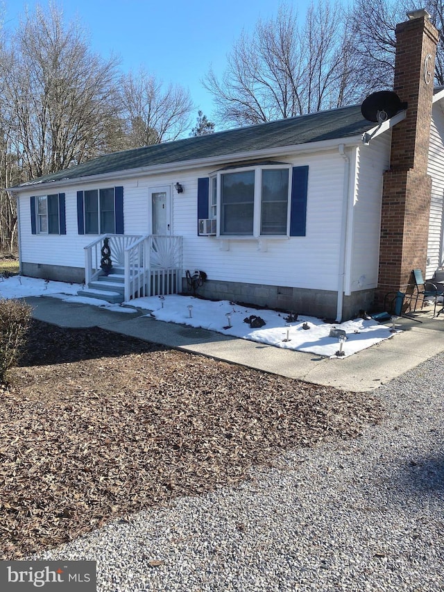 single story home with crawl space and a chimney