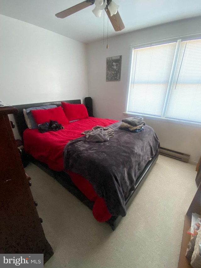 bedroom featuring baseboard heating, a ceiling fan, and carpet floors