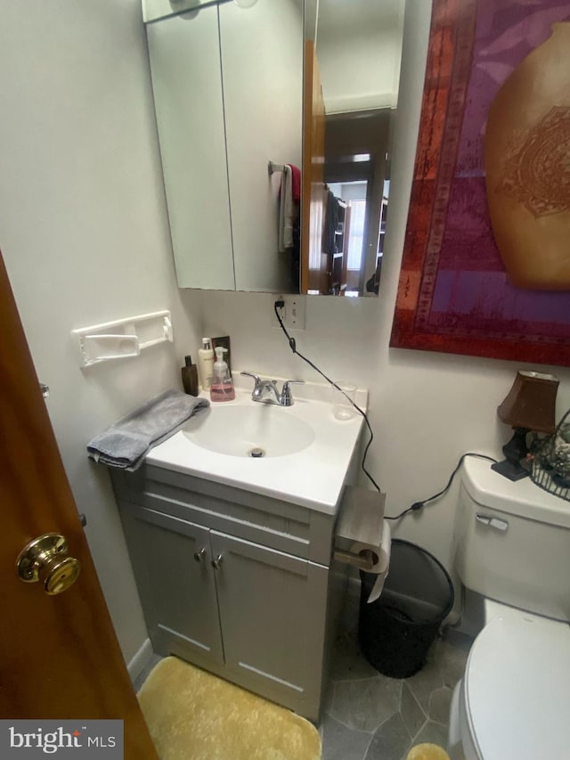 bathroom featuring vanity and toilet