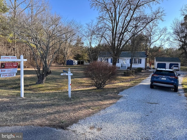 view of front of property with a front yard and driveway