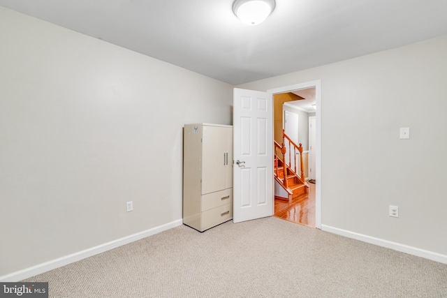 unfurnished bedroom featuring baseboards and carpet flooring