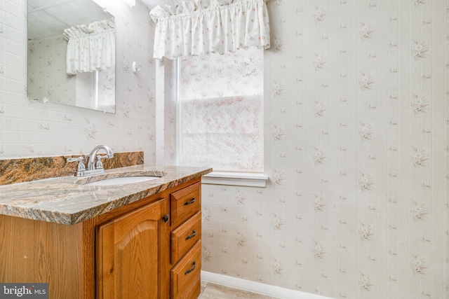 bathroom featuring wallpapered walls and vanity