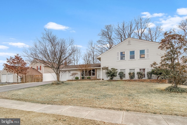 view of front facade featuring concrete driveway, a garage, fence, and a front yard