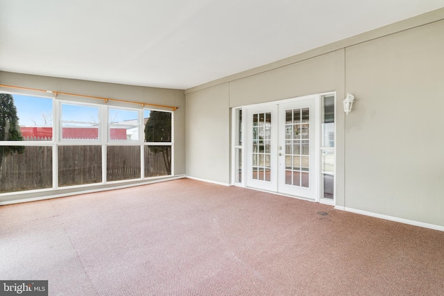 unfurnished room with carpet flooring, french doors, and baseboards