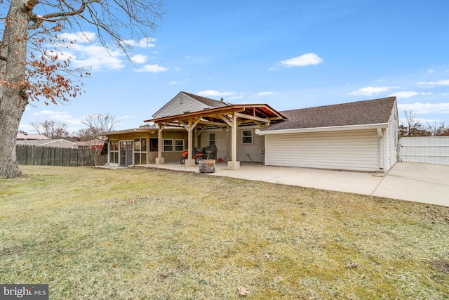 rear view of property with a patio, a yard, fence, and roof with shingles