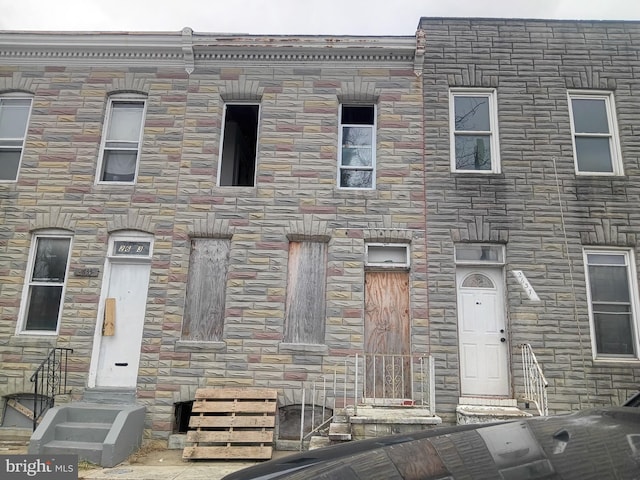 view of property featuring stone siding