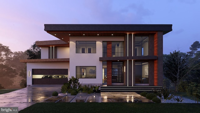 view of front of home with an attached garage, concrete driveway, and stucco siding