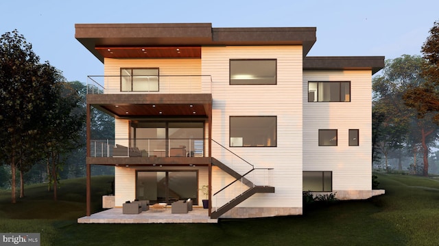 rear view of property with a patio area, a lawn, and a balcony