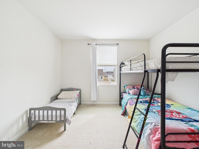 bedroom with carpet flooring and baseboards