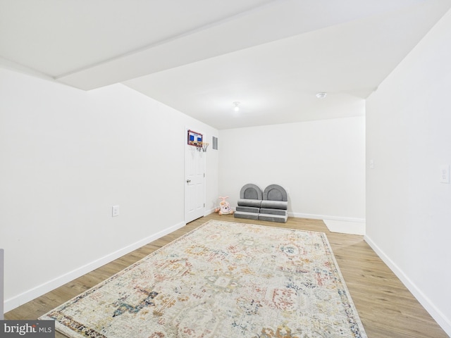 unfurnished room featuring baseboards and light wood finished floors