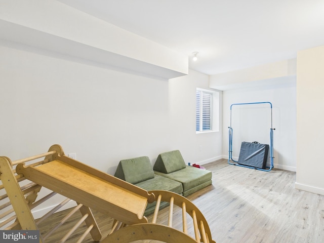 sitting room with light wood-style floors and baseboards