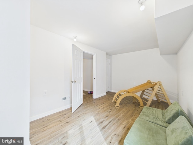 sitting room with wood finished floors and baseboards