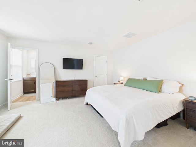 bedroom with light carpet and visible vents