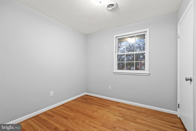 unfurnished bedroom with light wood-style flooring, visible vents, and baseboards