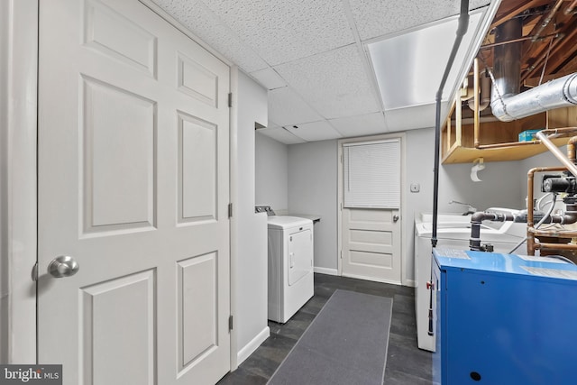 laundry area with baseboards, laundry area, and washer and clothes dryer