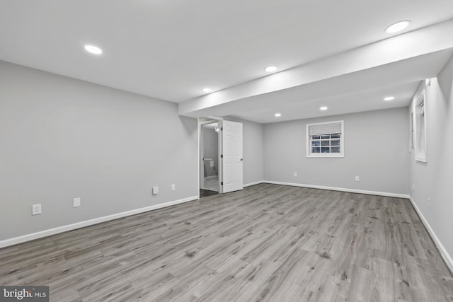 finished basement featuring recessed lighting, baseboards, and wood finished floors