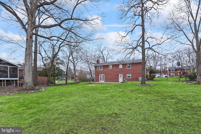 view of yard with a sunroom and fence