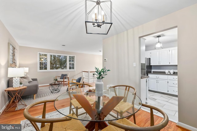 dining room with light wood-style floors and baseboards