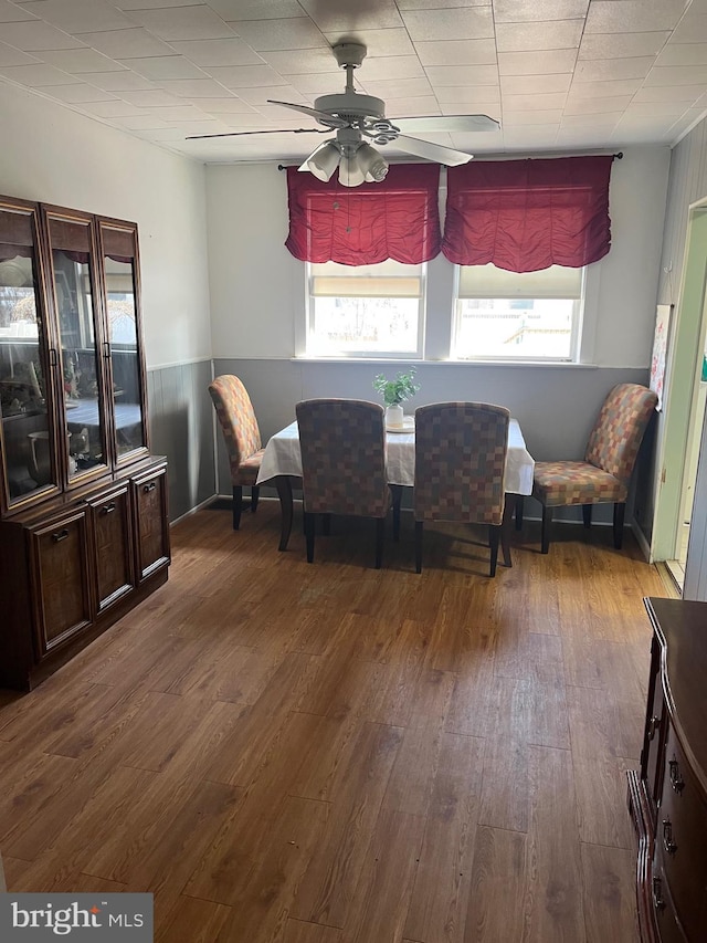 dining area with wood finished floors and a ceiling fan