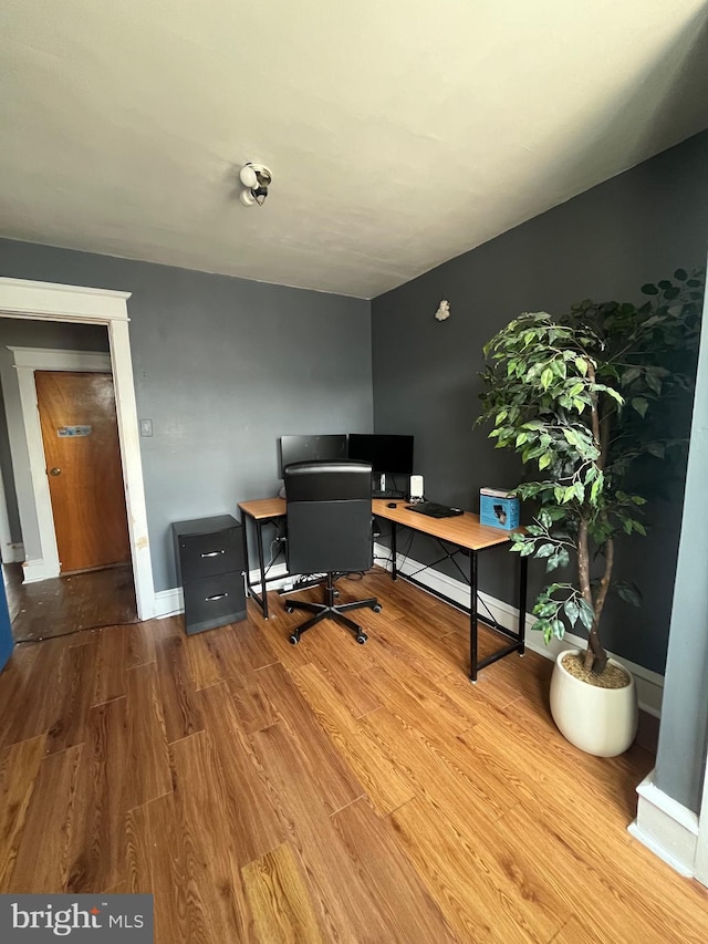 office area featuring baseboards and wood finished floors