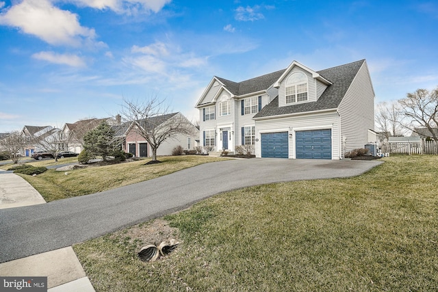 view of front of house with a front lawn, aphalt driveway, fence, roof with shingles, and a garage