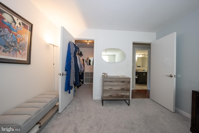 bedroom featuring carpet floors, a spacious closet, and a closet