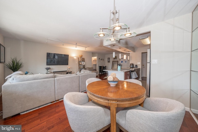 dining area featuring dark wood-style flooring