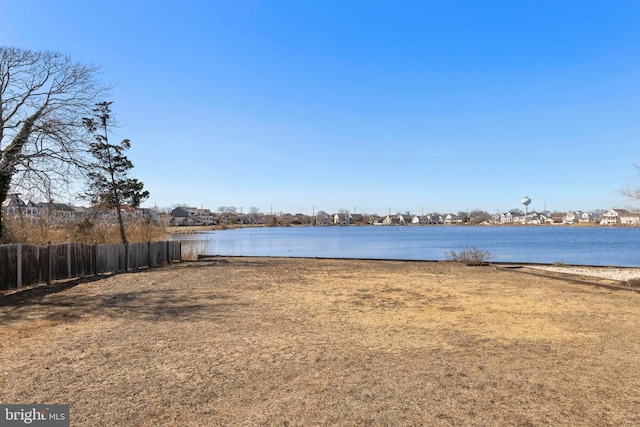 property view of water featuring fence