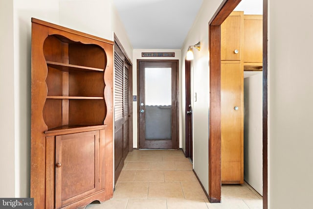 hall featuring light tile patterned floors