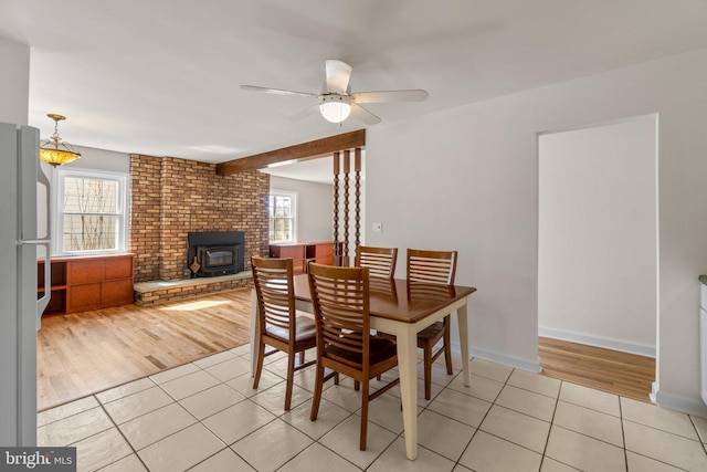 dining area featuring light tile patterned flooring, a healthy amount of sunlight, and ceiling fan