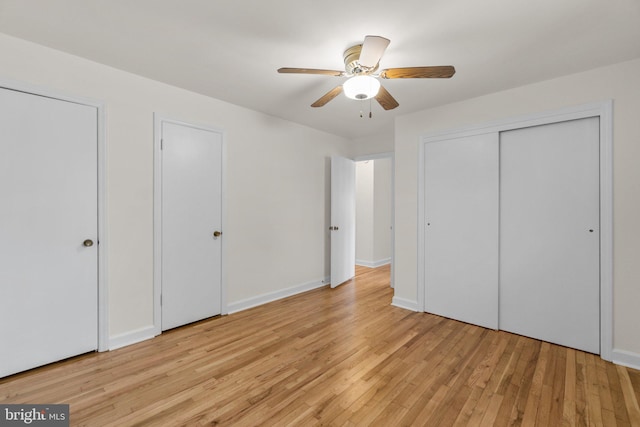 unfurnished bedroom featuring baseboards, light wood-style flooring, and a ceiling fan