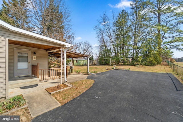 view of yard with a patio area, a porch, and fence