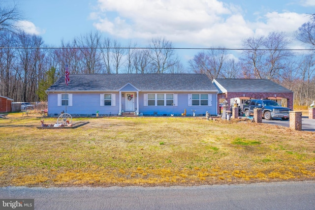 single story home featuring an attached carport and a front yard