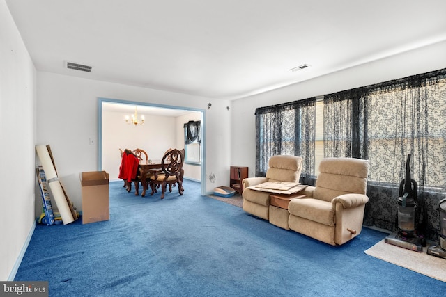 sitting room featuring a notable chandelier, visible vents, baseboards, and carpet