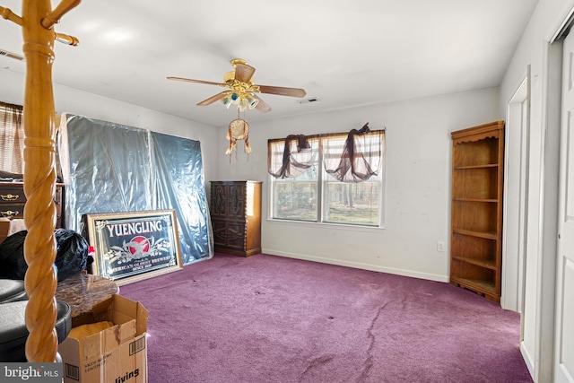 unfurnished room featuring baseboards, carpet floors, visible vents, and a ceiling fan