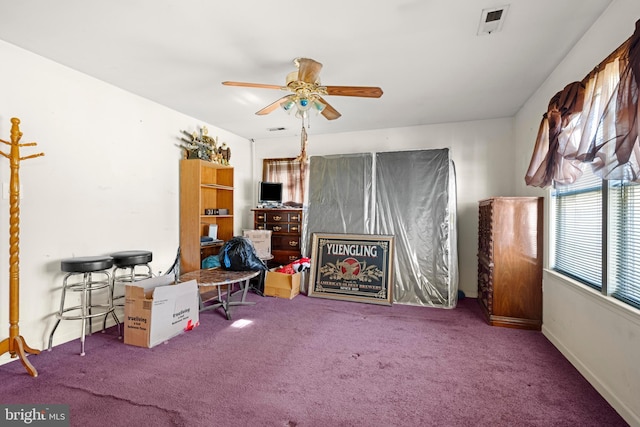 interior space featuring a ceiling fan, carpet, visible vents, and baseboards