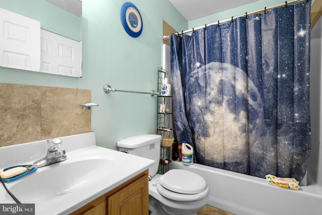 bathroom featuring vanity, shower / bath combination with curtain, and toilet