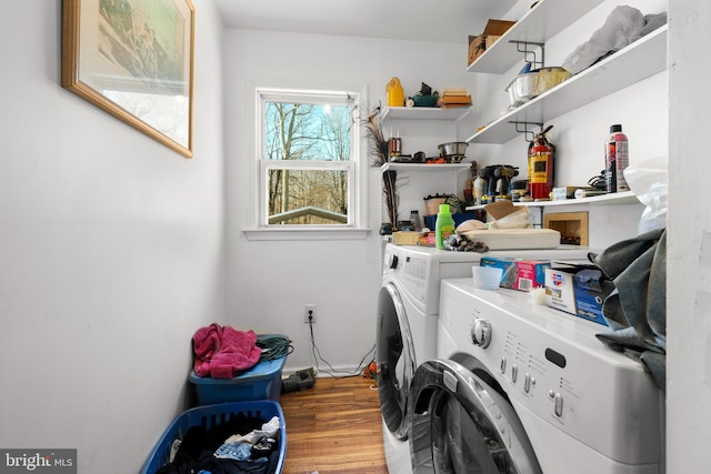 laundry area with laundry area, independent washer and dryer, and wood finished floors