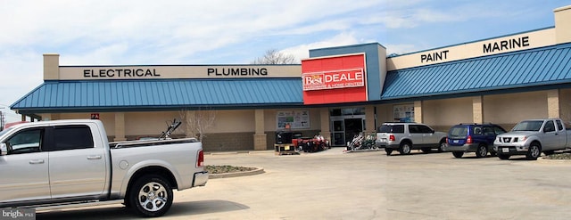 view of building exterior featuring uncovered parking