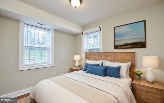 bedroom featuring visible vents and baseboards