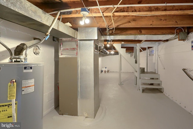 unfinished basement with water heater, stairway, and heating unit