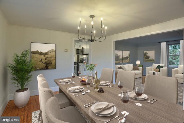 dining room featuring crown molding, a notable chandelier, baseboards, and wood finished floors