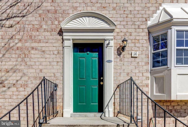 doorway to property with brick siding