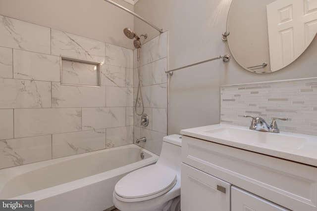 bathroom with vanity, toilet, tasteful backsplash, and shower / washtub combination