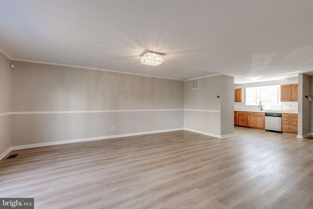 unfurnished living room featuring a sink, visible vents, crown molding, and light wood finished floors