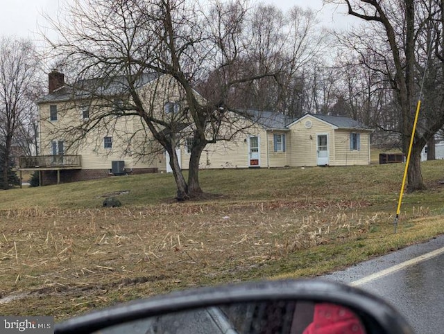 view of front of home with a chimney and a front yard